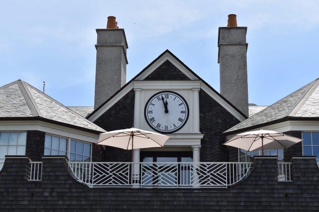A tower clock installed on the front of a home.