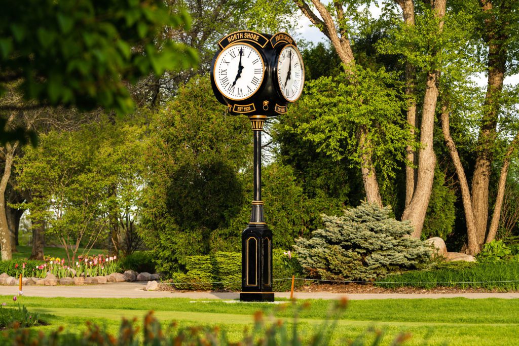 A unique landmark on a Golf Course of a Howard Four Face Replica 16 foot Post Clock.